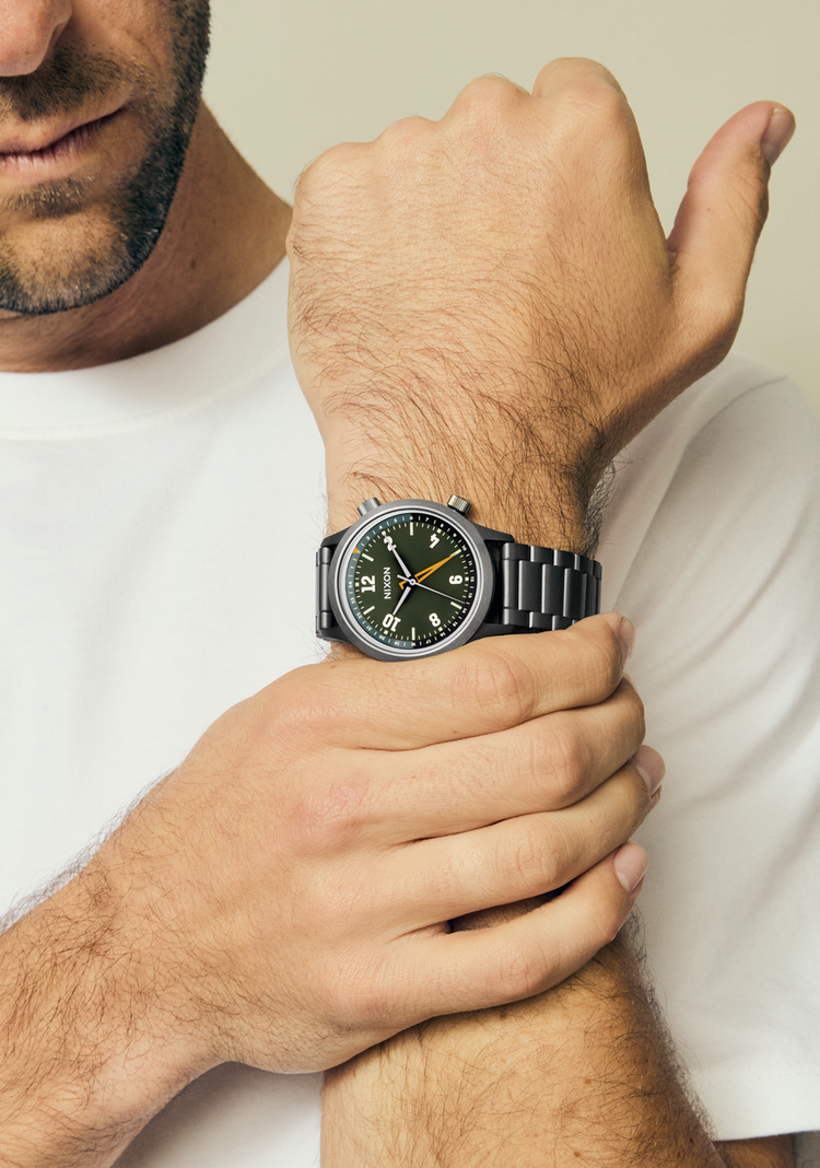 Man wearing the Nixon Drifter GMT watch