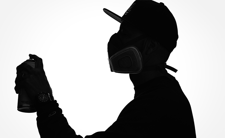 Silhouette of artist Damin Lujan and a spray paint can