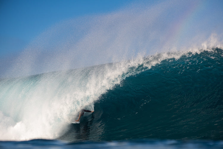 Surfer goes through a huge wave