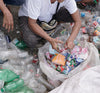 A person sorts through recycled materials.