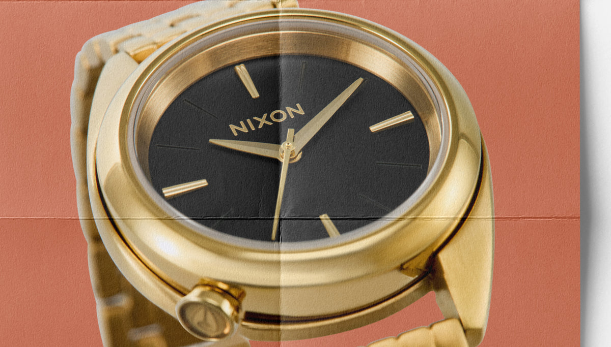 Detail shot of the gold Nixon Eddy watch made to look like a folded paper