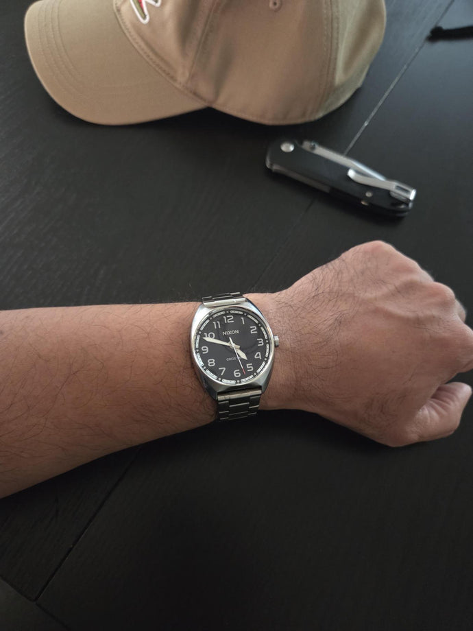 Man wearing a blue Nixon Mullet Stainless Steel watch.
