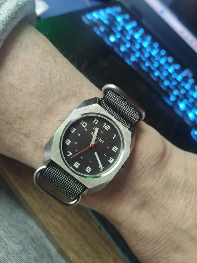 Person showing off their silver Nixon Scout watch